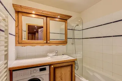 a bathroom with a sink and a washing machine at APARTMENT KANDAHAR - Alpes Travel - Central Chamonix - Sleeps 4 in Les Houches
