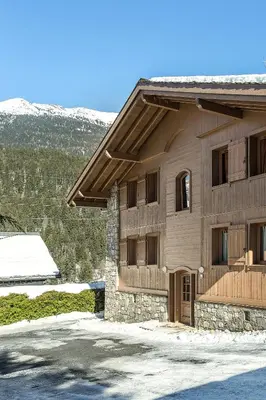a building with snow on the ground in front of it at APARTMENT KANDAHAR - Alpes Travel - Central Chamonix - Sleeps 4 in Les Houches