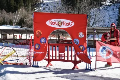 a person standing next to a playground in the snow at Appartement Le Caboen Les Planards in Chamonix-Mont-Blanc