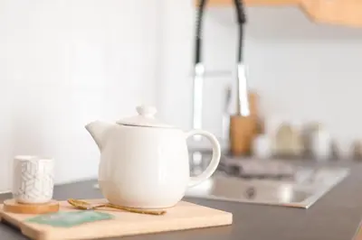 a white tea kettle sitting on a kitchen counter at Appartement Le Mazot Vue Mont Blanc in Chamonix-Mont-Blanc