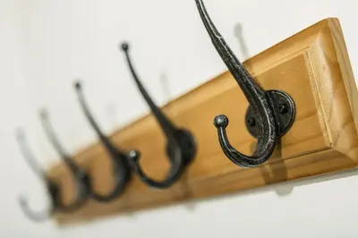a group of hangers hanging from a wall at Apartment Balme 5 - Chamonix Mont Blanc in Chamonix-Mont-Blanc