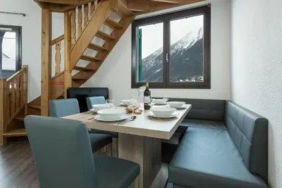 a dining room with a table and chairs at Apartment Balme 5 - Chamonix Mont Blanc in Chamonix-Mont-Blanc