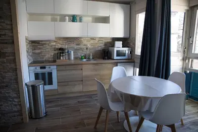 a kitchen with a table and chairs and a microwave at Castel des roches Leal Julien in Saint-Gervais-les-Bains