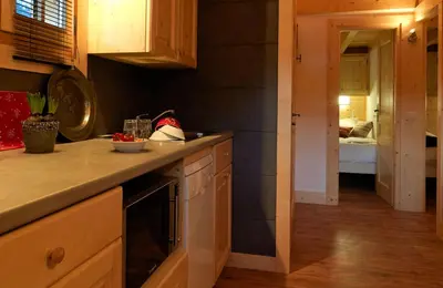a kitchen with wooden cabinets and a counter top at Chalets Ile des Barrats in Chamonix-Mont-Blanc
