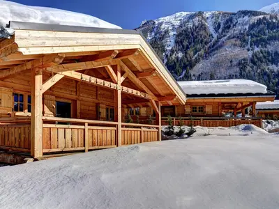 a log cabin in the mountains with snow at Chalets Ile des Barrats in Chamonix-Mont-Blanc