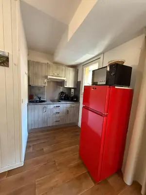a red refrigerator in a kitchen with wooden floors at La Comtesse in Saint-Gervais-les-Bains