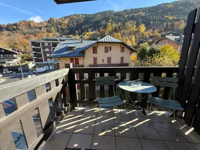 a patio with a table and chairs on a balcony at La Comtesse in Saint-Gervais-les-Bains