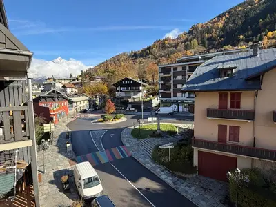 a van driving down a street in a city at La Comtesse in Saint-Gervais-les-Bains