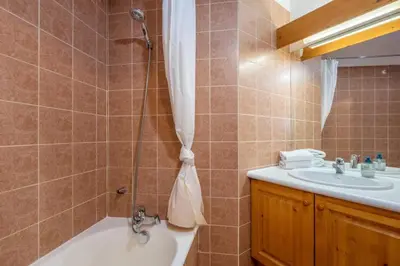 a bathroom with a shower and a tub and a sink at Petite Jardin: Residence Via des Traz B in Chamonix-Mont-Blanc