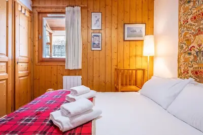 a bedroom with a bed with towels on it at Petite Jardin: Residence Via des Traz B in Chamonix-Mont-Blanc