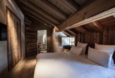 a bedroom with a large bed in a cabin at Zannier Le Chalet in Megève
