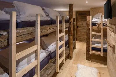 a room with three bunk beds in a cabin at Chalet De Praz Dru in Les Houches