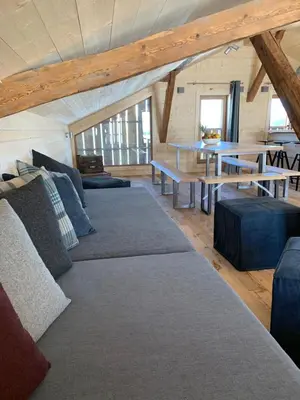 a living room with couches and tables in a attic at Chalet De Praz Dru in Les Houches