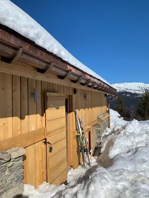a wooden cabin with snow on the side of it at Chalet De Praz Dru in Les Houches
