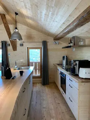 a kitchen with wooden walls and a wooden ceiling at Chalet De Praz Dru in Les Houches