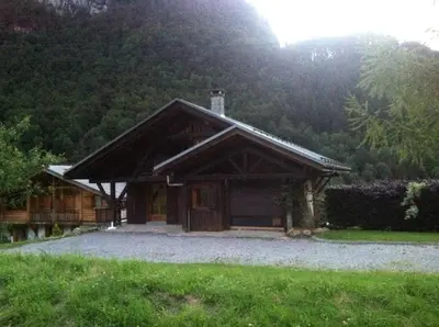 a house with a mountain in the background at Chalet Narcisse in Sixt