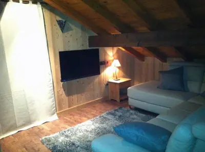 a living room with a couch and a flat screen tv at Chalet Narcisse in Sixt