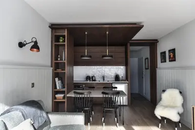 a kitchen and living room with a couch and a table at Appartement La Vallée Blanche avec parking gratuit in Chamonix-Mont-Blanc