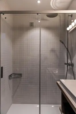 a shower with a glass door in a bathroom at Appartement La Vallée Blanche avec parking gratuit in Chamonix-Mont-Blanc