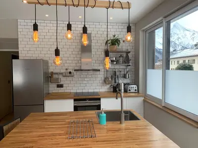 a kitchen with a wooden counter top and a sink at Apartment Maya, La Praz, Chamonix Mont Blanc in Chamonix-Mont-Blanc