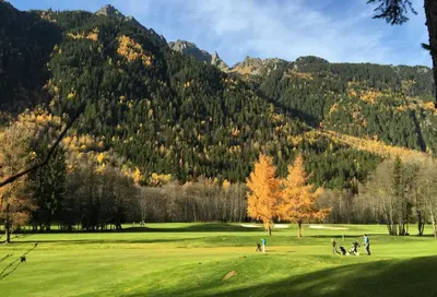 a group of people playing golf on a golf course at Apartment Maya, La Praz, Chamonix Mont Blanc in Chamonix-Mont-Blanc