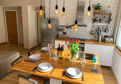 a kitchen with a wooden table with plates and glasses at Apartment Maya, La Praz, Chamonix Mont Blanc in Chamonix-Mont-Blanc