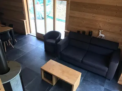 a living room with a couch and a table at Chalet La R'Batte in Sixt