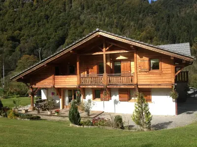 a log cabin with a porch and a balcony at Chalet La R'Batte in Sixt