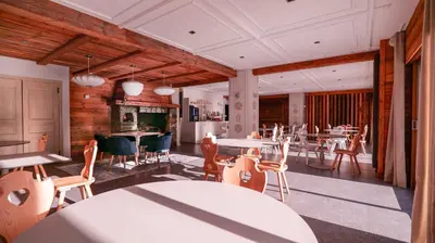 a dining room with a table and chairs at Hôtel des 2 Gares in Saint-Gervais-les-Bains