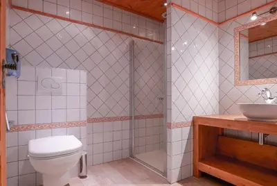 a bathroom with a toilet and a sink at Hôtel des 2 Gares in Saint-Gervais-les-Bains