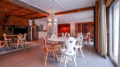a dining room with a table and chairs at Hôtel des 2 Gares in Saint-Gervais-les-Bains