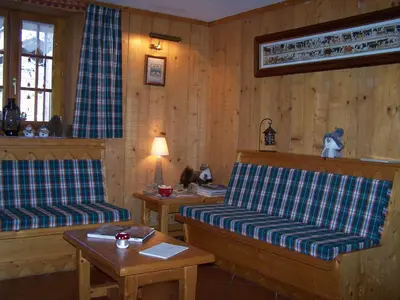 a living room with a couch and a table at le Montagny in Les Houches