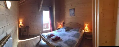 a bedroom with a bed in a wooden room at Chalet des Cascades in Sixt