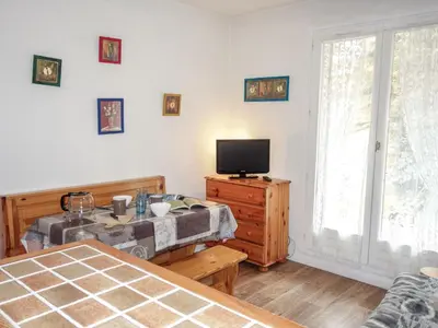 a bedroom with a bed and a tv on a dresser at Studio Sapin B by Interhome in Demi-Quartier