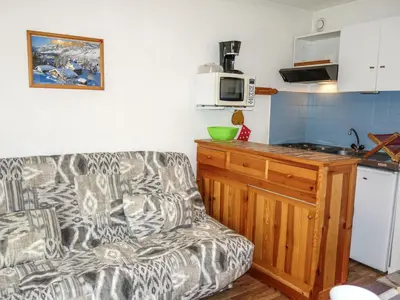 a living room with a couch and a kitchen at Studio Sapin B by Interhome in Demi-Quartier