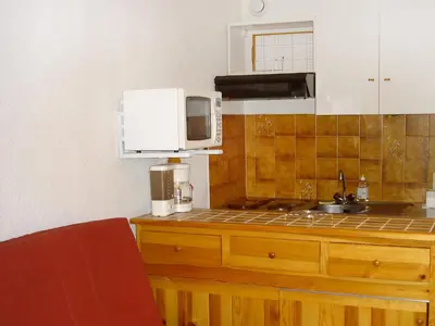 a kitchen with a sink and a microwave at Studio Sapin B by Interhome in Demi-Quartier