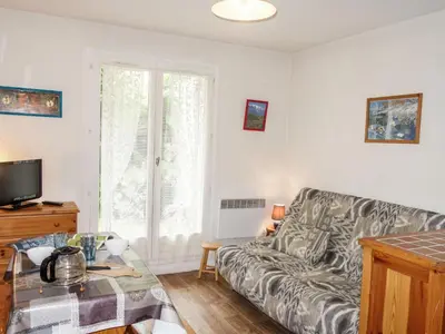 a living room with a couch and a table at Studio Sapin B by Interhome in Demi-Quartier