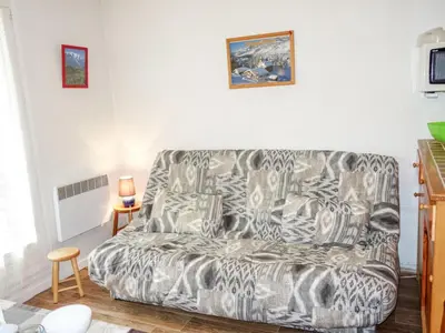 a living room with a couch and a table at Studio Sapin B by Interhome in Demi-Quartier