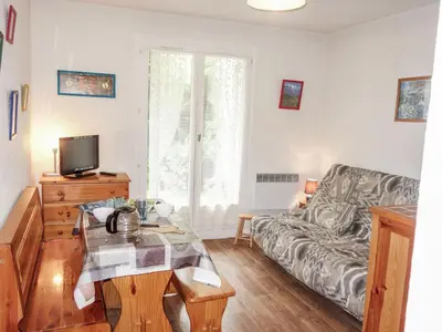 a living room with a couch and a table at Studio Sapin B by Interhome in Demi-Quartier