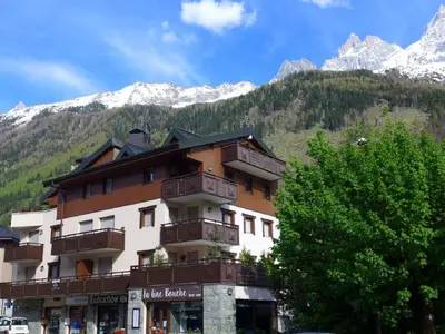 a building with balconies in front of a mountain at Apartment L'Espace Montagne-5 by Interhome in Chamonix-Mont-Blanc