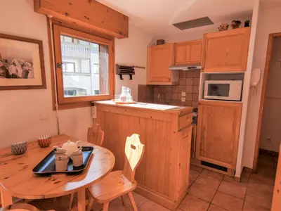 a kitchen and living room with a table and chairs at Apartment L'Espace Montagne-5 by Interhome in Chamonix-Mont-Blanc