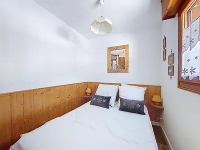 a bedroom with a white bed with two pillows at Apartment L'Espace Montagne-8 by Interhome in Chamonix-Mont-Blanc