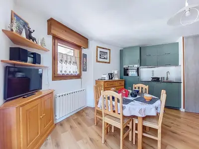 a kitchen with a table and a dining room at Apartment L'Espace Montagne-8 by Interhome in Chamonix-Mont-Blanc