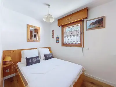 a bedroom with a white bed and a window at Apartment L'Espace Montagne-8 by Interhome in Chamonix-Mont-Blanc