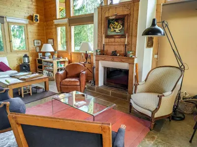a living room with wooden ceilings and a loft at Chalet L'Epachat by Interhome in Mémontel