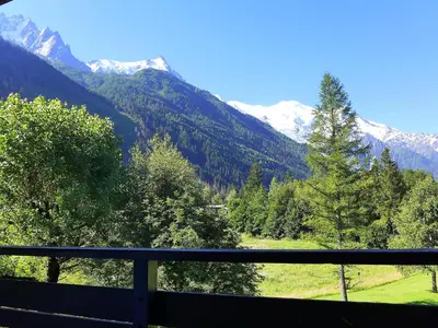a view of a mountain range from a balcony at Apartment Le Bois du Bouchet-1 by Interhome in Chamonix-Mont-Blanc