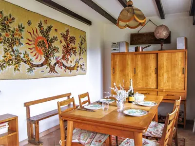 a dining room with a wooden table and chairs at Apartment Le Bois du Bouchet-1 by Interhome in Chamonix-Mont-Blanc