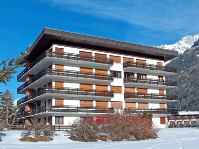 a tall building with snow in front of it at Apartment Le Bois du Bouchet-1 by Interhome in Chamonix-Mont-Blanc