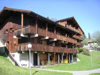 a house with a swimming pool in front of it at Apartment Les G'rets-7 by Interhome in Saint-Gervais-les-Bains