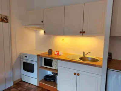 a kitchen with white cabinets and a sink at Apartment Les G'rets-7 by Interhome in Saint-Gervais-les-Bains